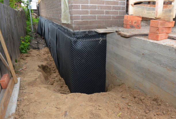Happy homeowners after waterproofing job in Howard